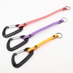 three lengths of biothane clicker straps with carabiner clip on a white background