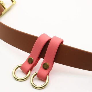 close up of caramel biothane utility belt with coral accents
