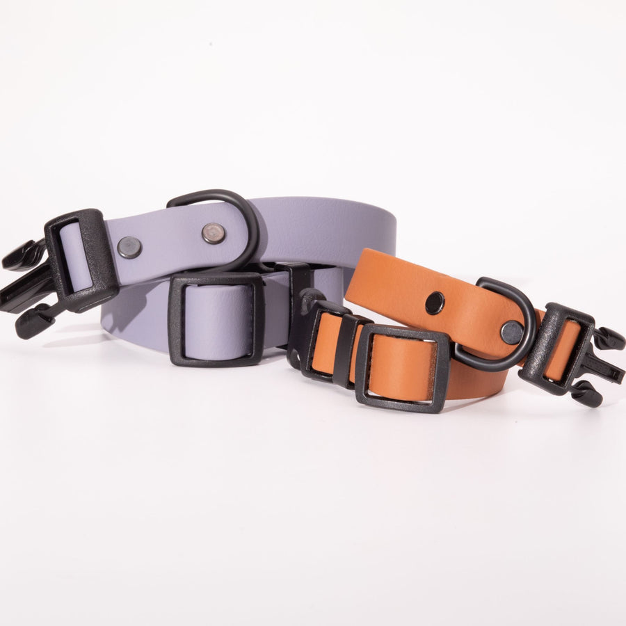 two biothane dog collars with sport hardware in graphite and poppy on white background