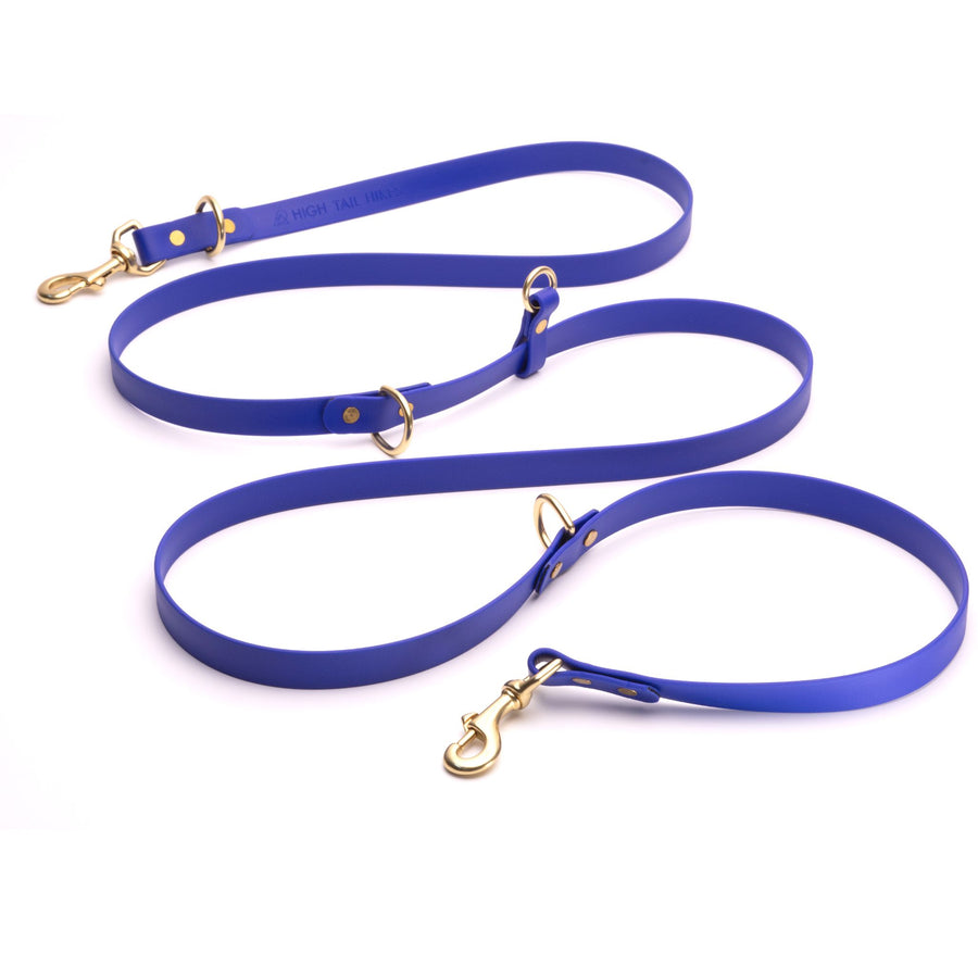 long dark blue biothane dog leash with brass hardware on white background